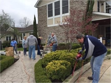 Volunteers doing yard work at Cornerstone of Hope